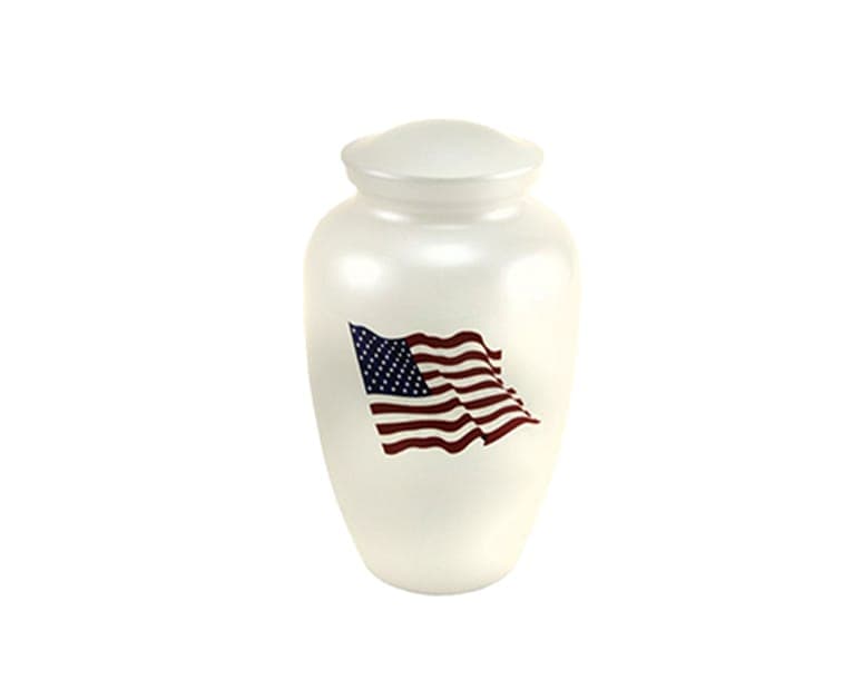 A white cremation urn with an American flag motif
