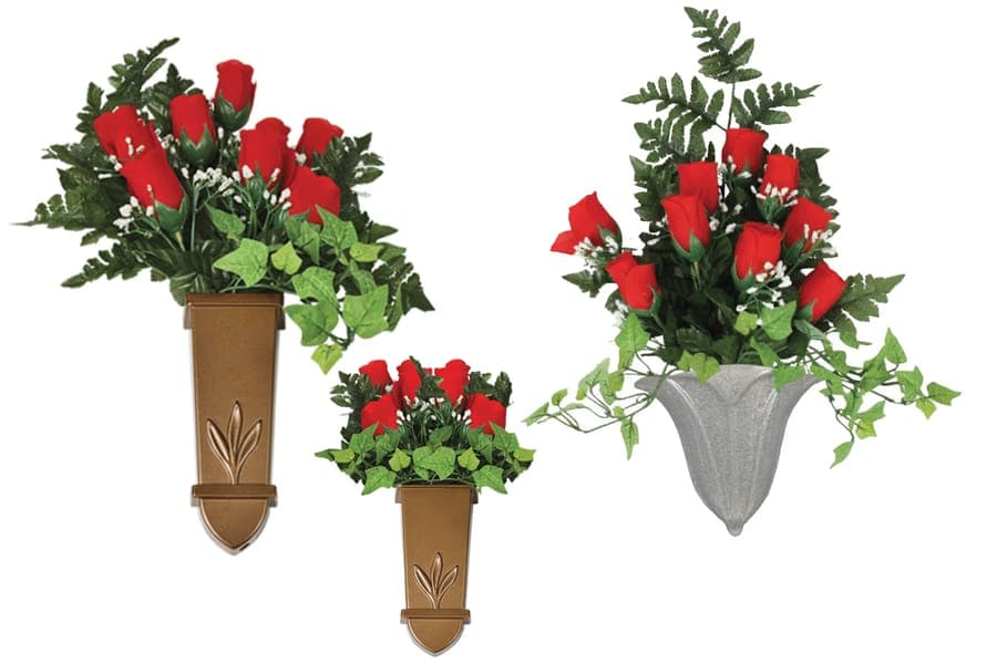 Bronze and granite wall-mount cemetery vases filled with red silk roses