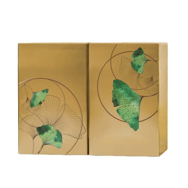 A pair of gold-toned companion urns decorated with green ginkgo leaves