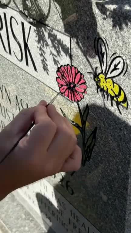Mark hand-painting a memorial